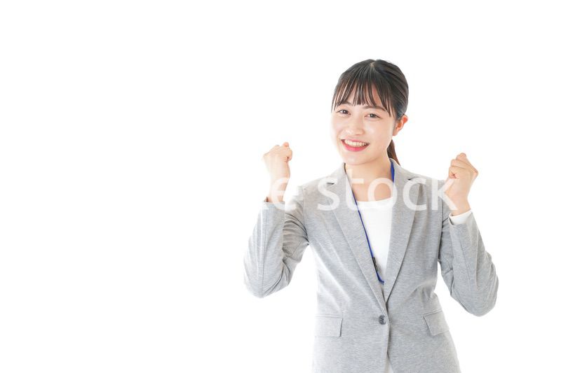 ガッツポーズをする若いキャリアウーマン