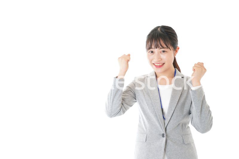 ガッツポーズをする若いキャリアウーマン