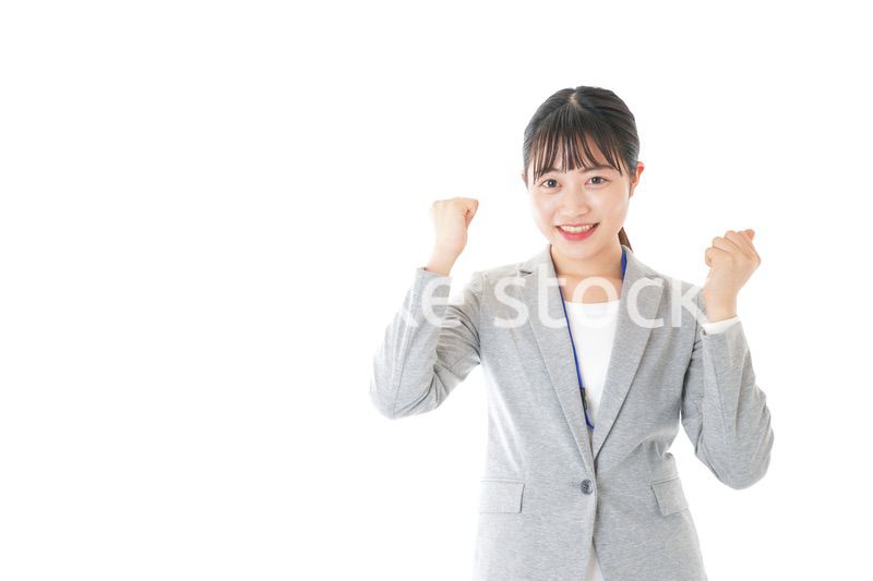ガッツポーズをする若いキャリアウーマン