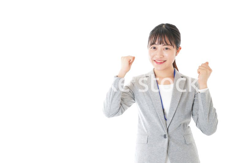 ガッツポーズをする若いキャリアウーマン