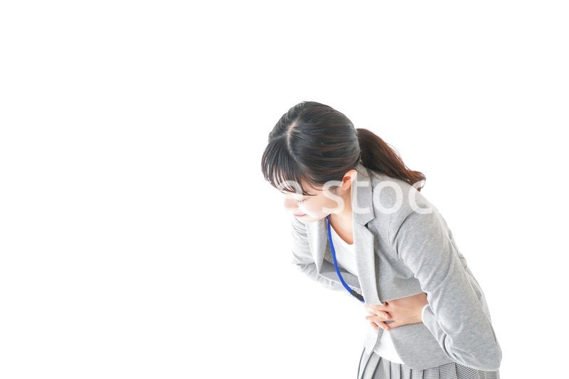 腹痛で苦しむ若いキャリアウーマン