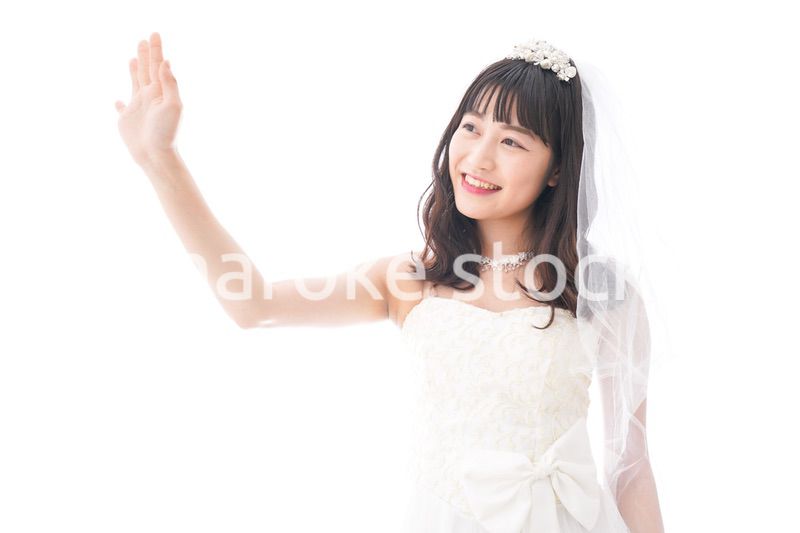 手をふるドレス姿の花嫁