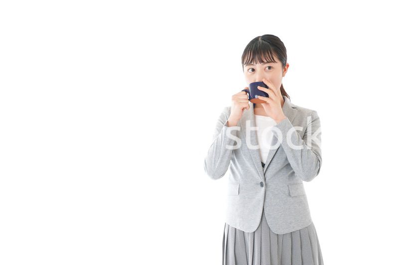 笑顔でコーヒーを飲む若いビジネスウーマン