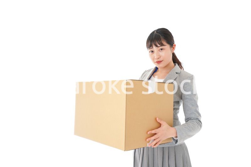 荷物を運ぶ若いビジネスウーマン