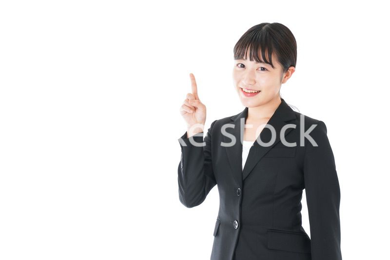 ポイントを示すスーツを着たビジネスウーマン