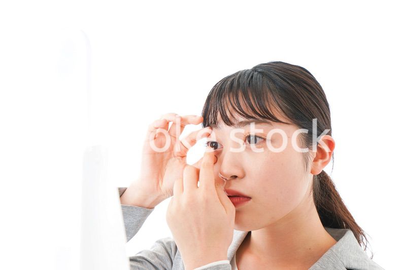 コンタクトレンズを入れるビジネスウーマン