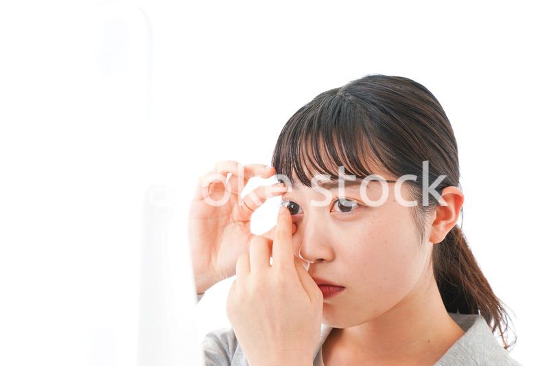 コンタクトレンズを入れるビジネスウーマン