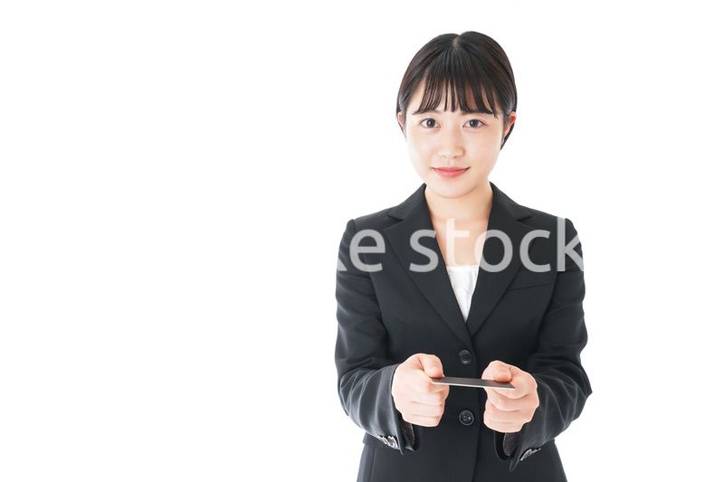 名刺交換をするスーツを着たビジネスウーマン