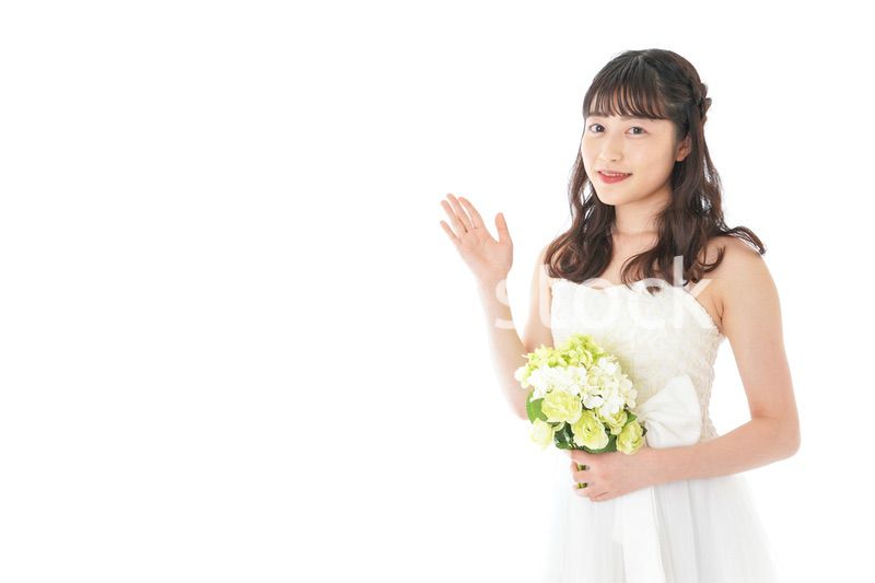 ブーケを持ち指差す花嫁の女性