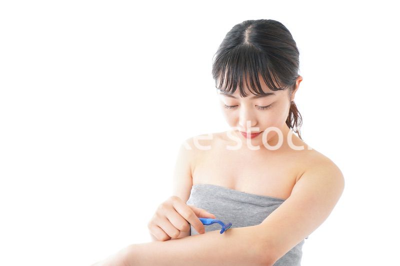 肌の脱毛をする若い女性