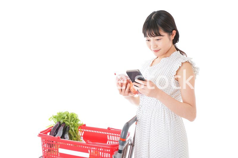 スーパーで食料品を調べる若い女性