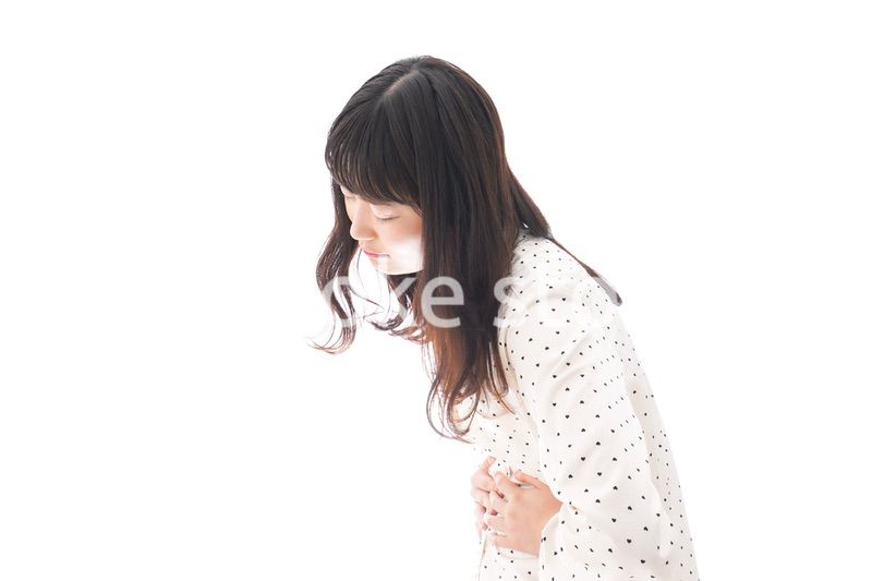 腹痛で苦しむ若い女性