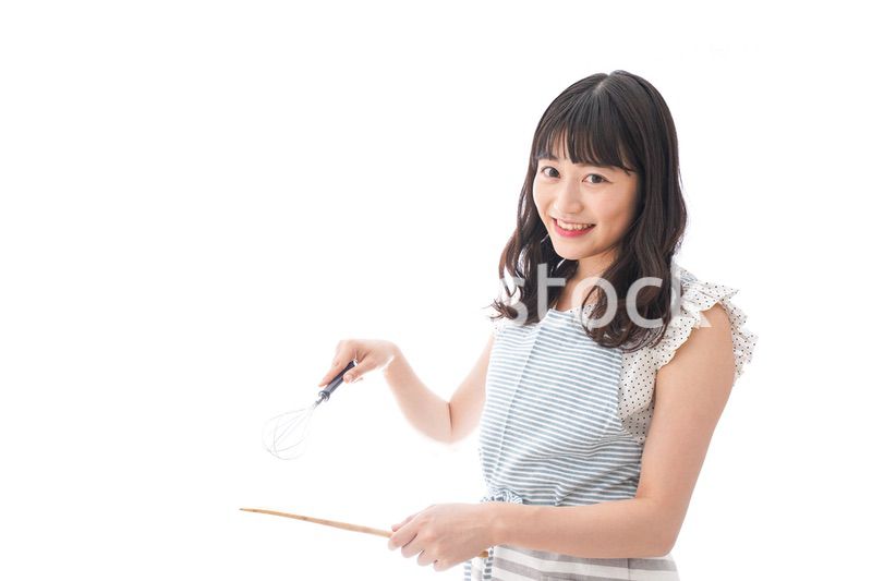 エプロンを着てごはんを作る若い女性