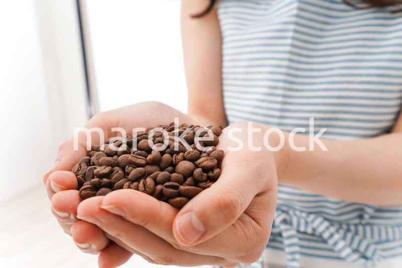 コーヒー豆を持つ若い女性