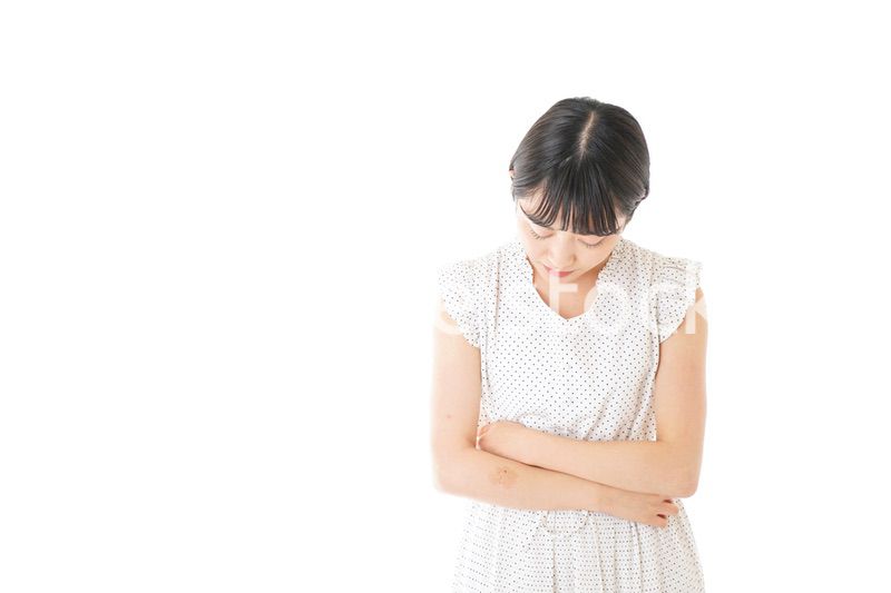 腹痛に苦しむ若い女性