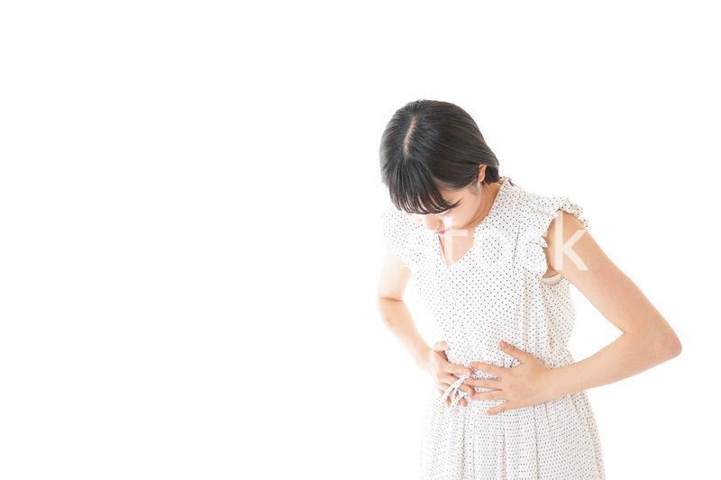 腹痛に苦しむ若い女性