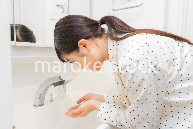 顔を洗う若い女性