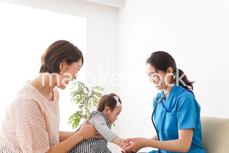 赤ちゃんの診察をする若いドクター