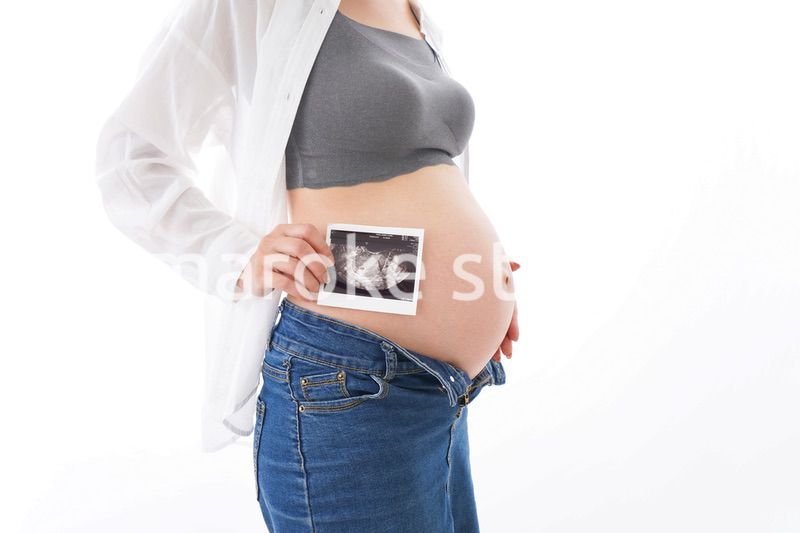 エコー画像を持つ若い妊婦
