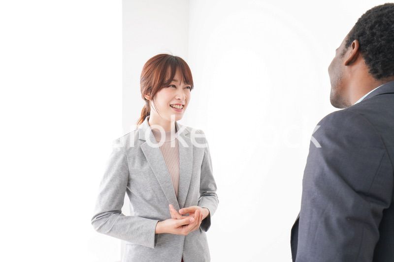 オフィスで意見交換をする2人のビジネスパーソン