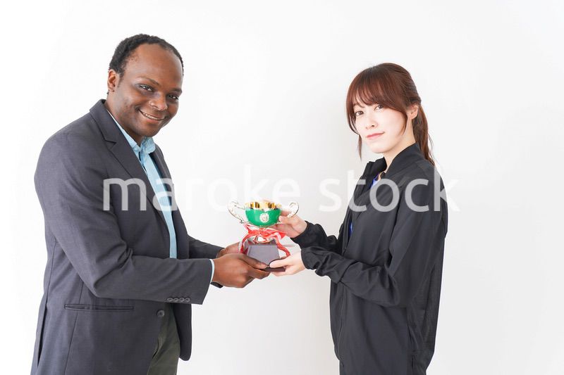 優勝トロフィーを受け取る人