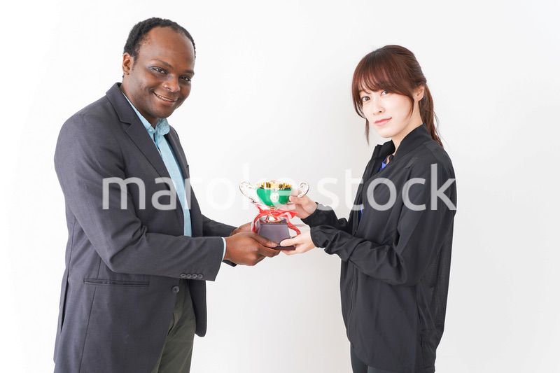 優勝トロフィーを受け取る人