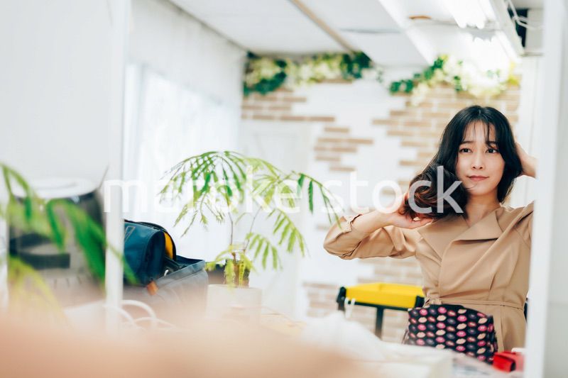 笑顔でメイクをする若い女性