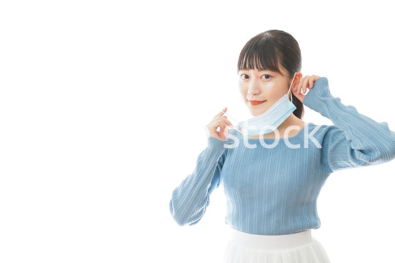 マスクを付けるカジュアルな服装の女性