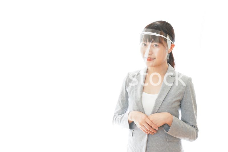 フェイスシールドをして働く若いビジネスウーマン