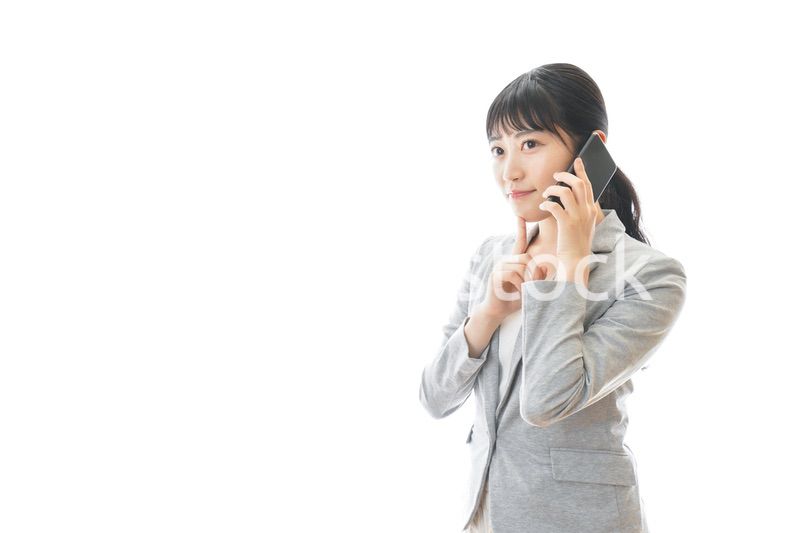 スマホで通話をする笑顔のビジネスウーマン