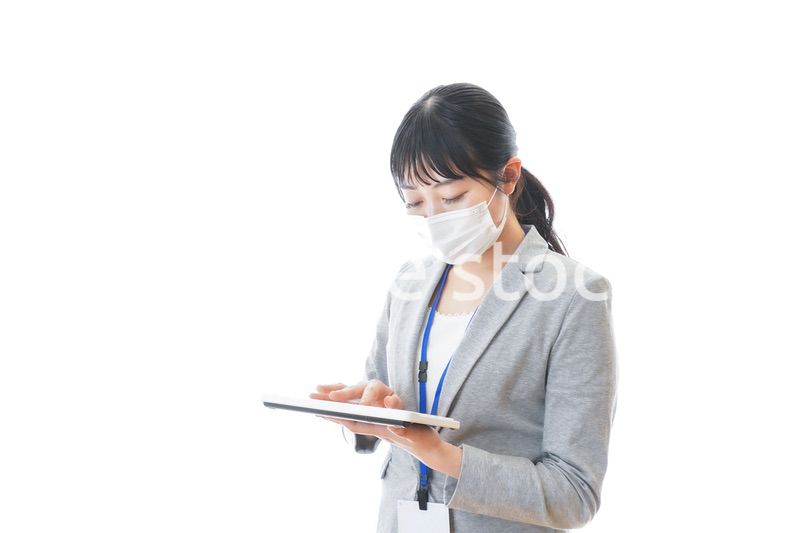 マスクをしてキーボードを持つ若いビジネスパーソン