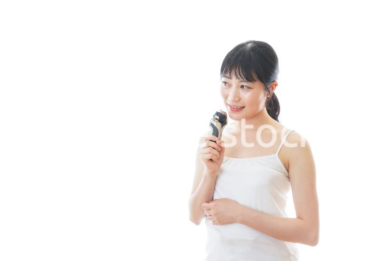 髭剃りを使う若い女性