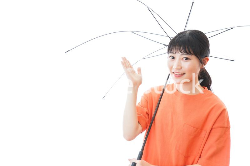 ビニール傘を指す若い女性