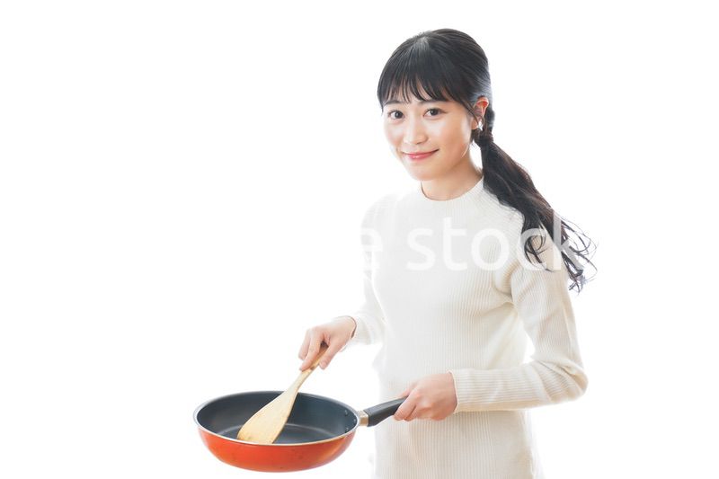 自宅で料理をする一人暮らしの女性