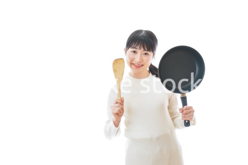 自宅で料理をする一人暮らしの女性