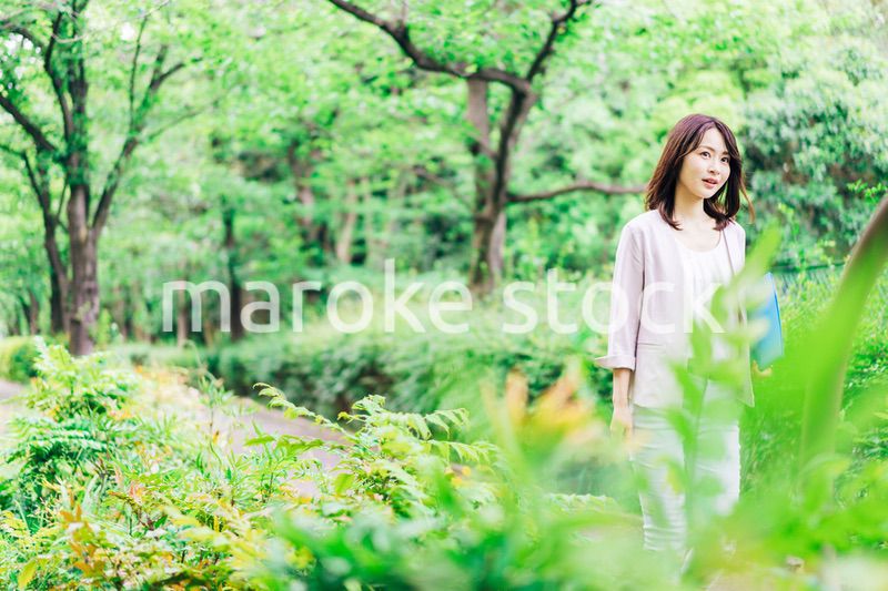 書類を持って歩く若いビジネスウーマン