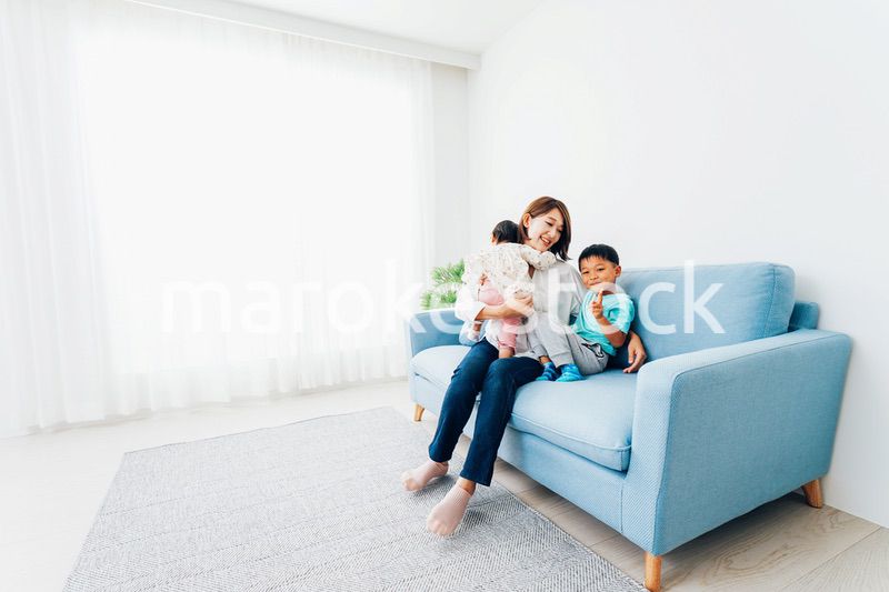 家で子どもたちと遊ぶ若い主婦
