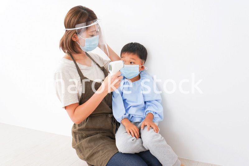 園児の検温をする保育士