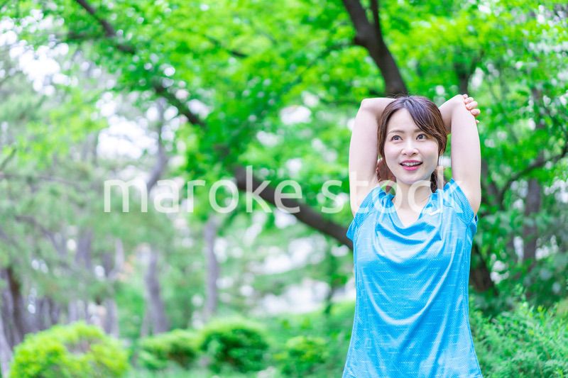 自然の中でストレッチをする若い女性