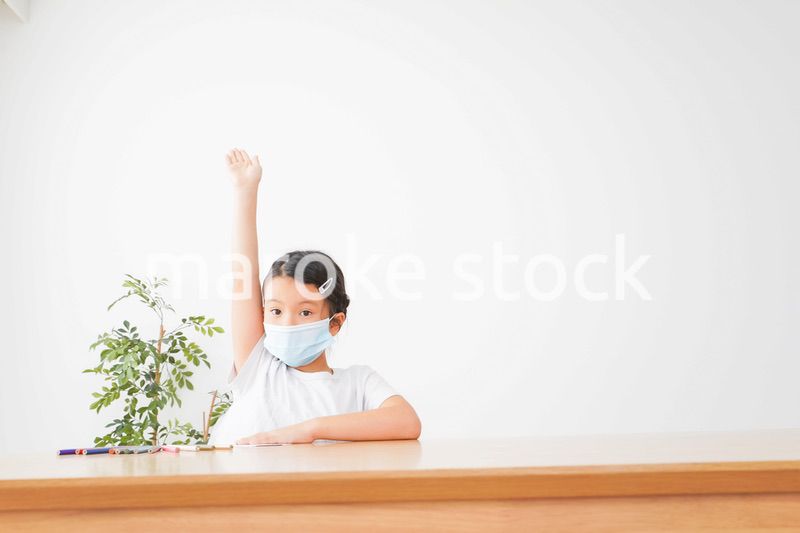 マスクをして発表をする小学生