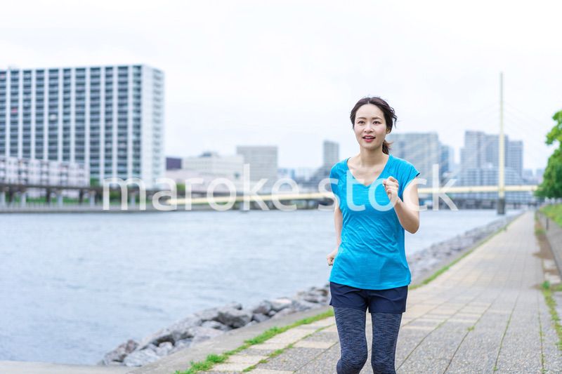 自然の中でランニングをする若い女性