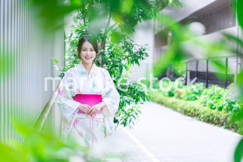 浴衣を着て街を歩く若い女性