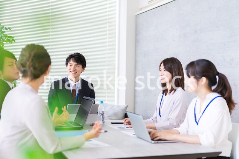 明るいオフィスでミーティングをするビジネスパーソン