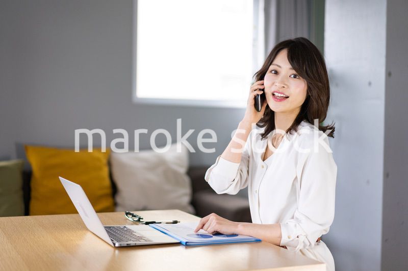 仕事の電話をする若い女性