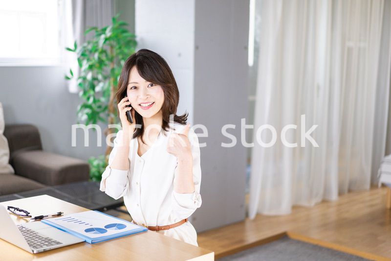 仕事の電話をする若い女性