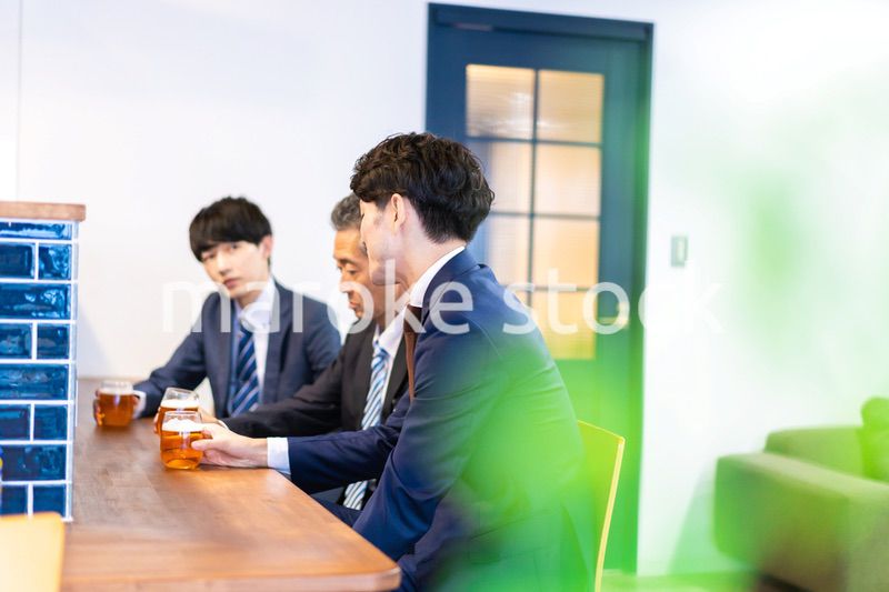 バーで乾杯をする3人の会社員