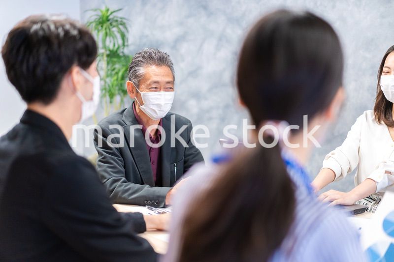 マスクをして会議をするビジネスパーソン