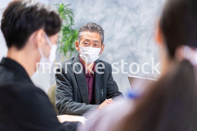 マスクをして会議をするビジネスパーソン