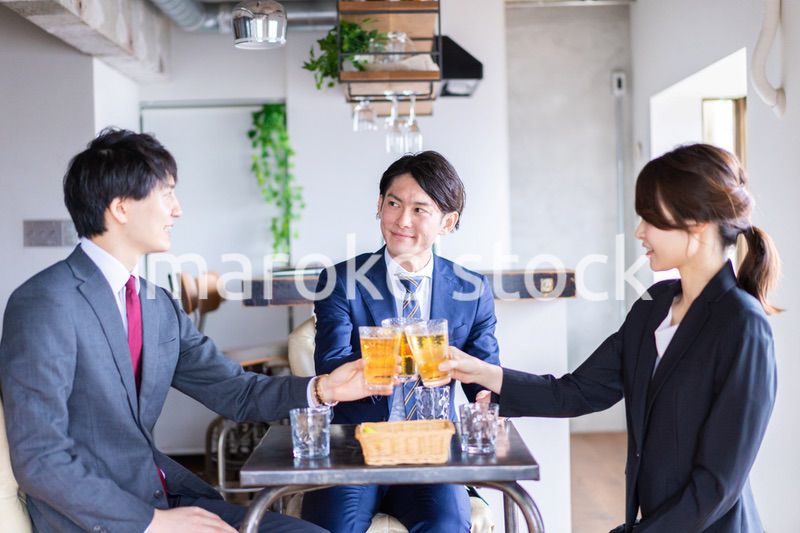 お酒を飲みながら話すビジネスパーソン