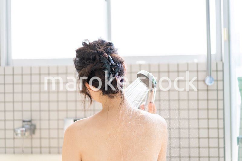 お風呂でシャワーを浴びる若い女性
